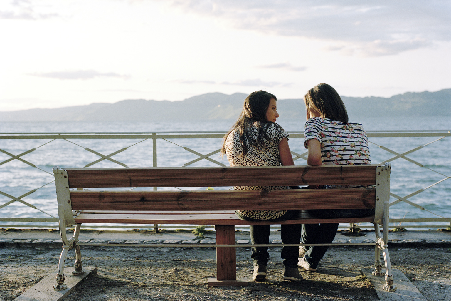 Deux jeunes filles discutent sur un banc